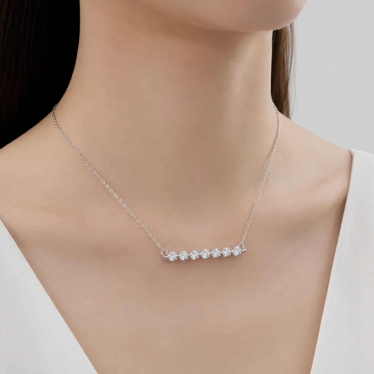Model wearing a diamond pendant necklace